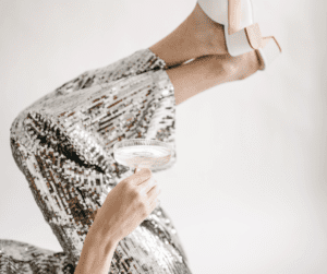 A woman celebrating with champagne glass for habits to improve mental health. 
