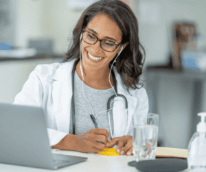 Image of a female doctor having an appt with patient, outlining the importance of speaking to a medical professional about migraine at work. 