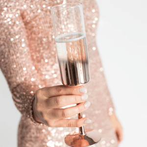 Image of woman holding drinking for new years about migraine holiday season. 