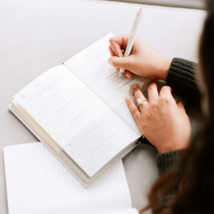 Woman journaling for stress management. 