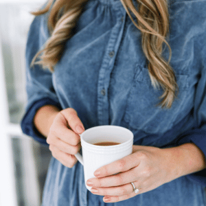 Image of woman holding tea cup. 