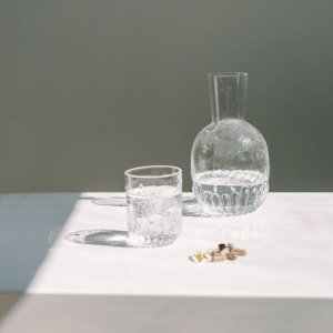 Image of water and medication for showing treatment of migraines. 