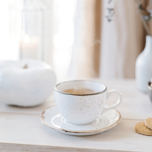 Image of white tea cup on saucer for best tea for ibs. 