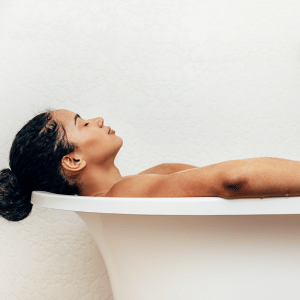Image of woman in bath for heat to relieve nerve pain. 