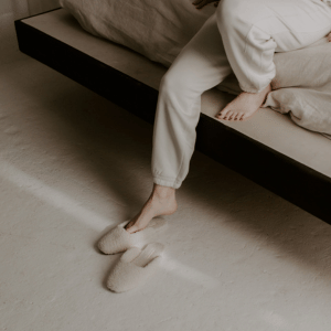 Woman getting out of bed slowly. She is wondering about can fibromyalgia cause shortness of breath?