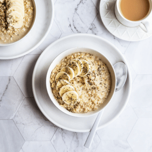 Image of a bowl of oatmeal with chia seeds ontop and cut bananas.