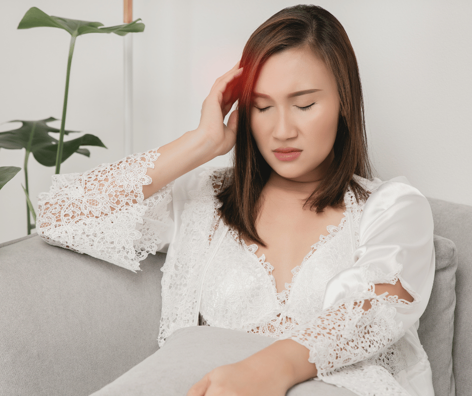 Woman holding her head with migraine pain and migraine symptoms. 